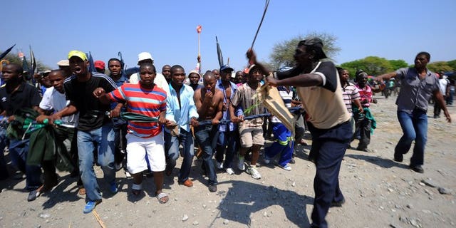 Some of 12,000 miners sacked by Amplats last year protest at Bleskop Stadium in Rustenburg last October. Some 5,600 mineworkers at the world's top platinum producer Anglo American Platinum downed tools overnight at the firm's South African operations, demanding the reinstatement of suspended union leaders, the company said Monday.