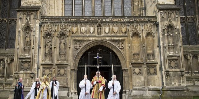 The Archbishop of Canterbury, Justin Welby (3-L) leaves from the West Door at Canterbury Cathedral on March 21, 2013. The Church of England voted Monday to restart the process that would lead to ordaining women bishops after traditionalists blocked the idea last year, plunging the church into turmoil.