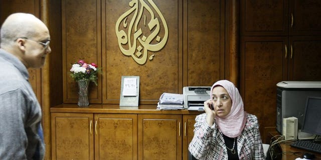 Al-Jazeera employees work at the pan-Arab television channel's bureau in Cairo on January 30, 2011. Several Al-Jazeera employees in Egypt have resigned because they disagreed with their employer's editorial line, an official at the Qatari television told AFP on Monday.