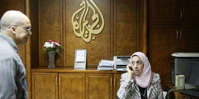 Al-Jazeera employees work at the pan-Arab television channel's bureau in Cairo on January 30, 2011. Several Al-Jazeera employees in Egypt have resigned because they disagreed with their employer's editorial line, an official at the Qatari television told AFP on Monday.