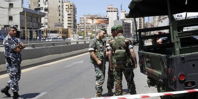 Lebanese security forces stand guard in Beirut on May 26, 2013. A car bomb on Tuesday rocked Beirut's Hezbollah stronghold in the southern suburbs, which is populated mainly by Shiite Muslims.