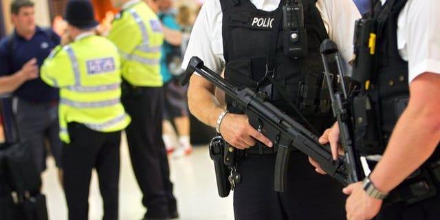 Armed police officers patrol in London on August 2, 2005. A man believed to be armed is holding a two-year-old girl at a house in Kidlington, Oxford, police said on Tuesday.