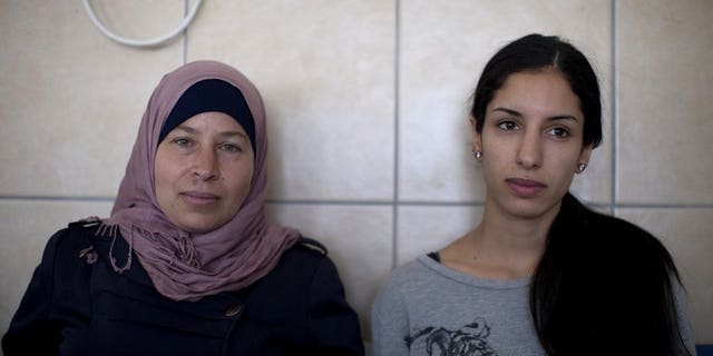 Palestinian activist Nariman a-Tamimi (left) and Rana Hamadah sit for the verdict during their trial at Israel's Ofer military court near the West Bank city of Ramallah on July 9, 2013. An Israeli military court formally charged two Palestinian women for their involvement in a peaceful demonstration in the West Bank last month.