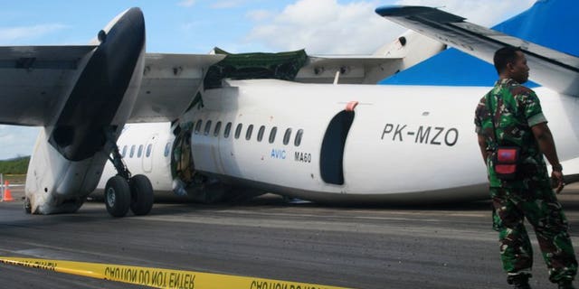 An Indonesian soldier stands guard next to an MA60 Merpati Airlines plane after it crash-landed in Kupang on June 10, 2013. New Zealand said it had suspended a multi-million-dollar aid programme in Tonga over safety concerns stemming from the Pacific nation's plans to use the Chinese-made plane for domestic services.