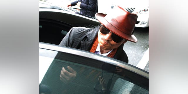 Kenichi Shinoda, the boss of Japan's largest yakuza gang, the Yamaguchi-gumi, gets into a car in Kobe, on April 9, 2011.