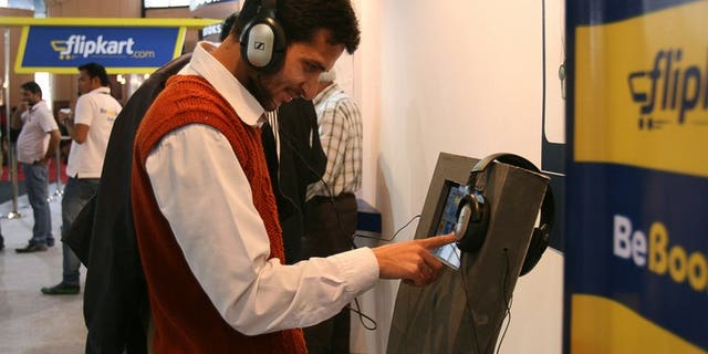A visitor browses through books of Indian online book retailer Flipkart on a screen at the New Delhi World Book Fair in New Delhi on February 25, 2012. India's top e-commerce company Flipkart said Wednesday it has raised $200 million from private investors in what it called the biggest one-time investment in an Indian online retail firm.