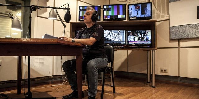 A worker at Greek state broadcaster ERT edits a news bulletin, in Athens on July 10, 2013. The network went back on air, one month after the government abruptly pulled the plug on state broadcaster ERT causing national and international uproar.