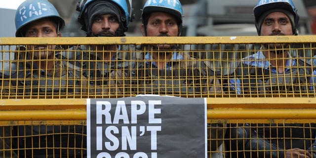 Indian Rapid Action Force personnel stand behind a barricade in New Delhi on December 31, 2012. A juveniles' court in New Delhi hearing the case of a teenager suspected of taking part in a gang-rape last December that shocked India has deferred announcing a verdict until July 25, a prosecutor said.