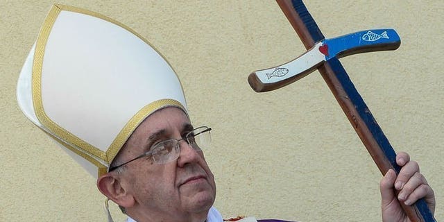 Pope Francis leads a mass during a visit to the Italian island of Lampedusa, on July 8, 2013. Pope Francis has bolstered criminal legislation against child abuse in the Vatican in an overhaul of laws that apply to the clergymen and lay people who work in the tiny city state.