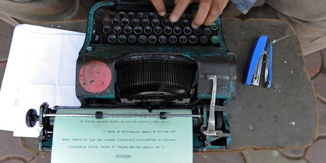 An office worker types out an affidavit in Mumbai, on February 15, 2011. A Russian state service in charge of safeguarding Kremlin communications is looking to purchase an array of old-fashioned typewriters to prevent leaks from computer hardware, sources have told AFP.
