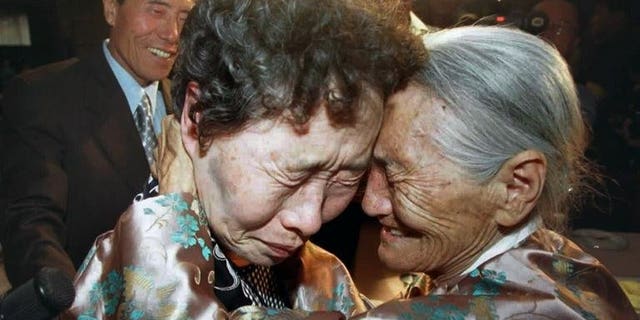 North Korea's Chung Duck-Hwa (right) embraces Chung Myung-Hoi -- her long-separated sister from South Korea -- during a family reunion in Pyongyang, on August 15, 2000. North Korea has retracted its proposal to hold talks with South Korea on restarting a family reunion programme, a Seoul official has told AFP.