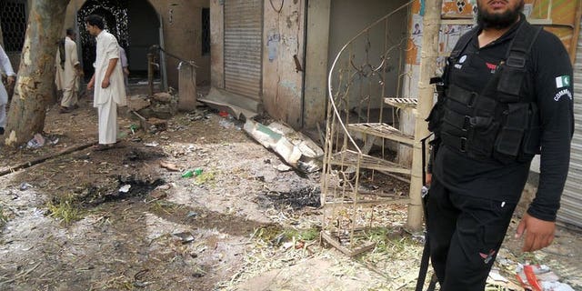A Pakistani policeman stands at the site of a motorcycle bomb explosion in the northwestern province of Khyber Pakhtunkhwa, on July 11, 2013. At least two people were killed and five others wounded when a motorcycle bomb exploded at a roadside restaurant in northwest Pakistan.