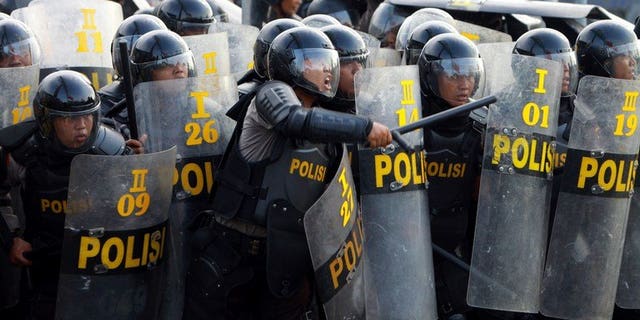 Indonesian police during a protest in Medan on March 26, 2012. Around 200 prisoners escaped from an Indonesian jail Thursday after violent riots erupted, with inmates setting fire to the prison and hurling bottles at guards.
