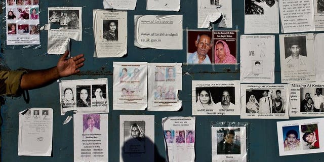 Portraits of missing pilgrims are seen on the gates of the Jolly Grant Airport in Dehradun, Nepal, on June 26, 2013. The death toll from recent floods triggered by heavy monsoon downpours in Nepal has climbed to at least 60, police told AFP.