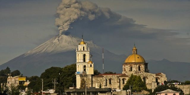 Ash spews from Mexico's Popocatepetl volcano, some 55 km from Mexico City, as seen from San Damian Texoloc in the Mexican central state of Tlaxcala, on July 9, 2013. A handful of US flights were canceled at two Mexican airports on Friday after ash from a nearby volcano fell in central Mexico, authorities said.