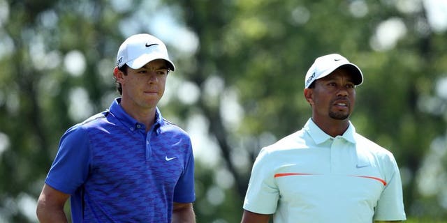 Rory McIlroy of Northern Ireland (L) and Tiger Woods of the US, pictured during the 113th US Open, at Merion Golf Club in Ardmore, Pennsylvania, on June 15, 2013. Woods and McIlroy will go head-to-head in a two-man exhibition for the second time in China following last year's outlandish Duel at Jinsha Lake, organisers announced on Saturday.