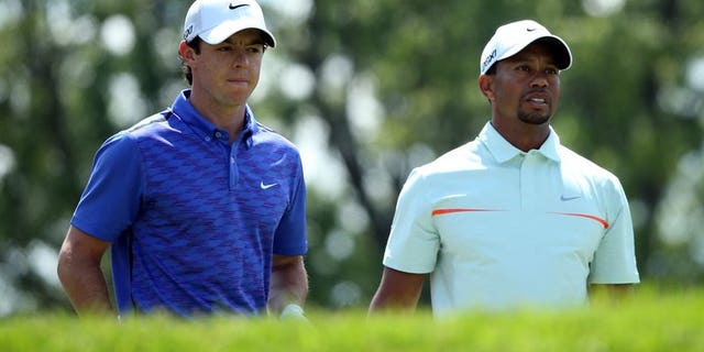Rory McIlroy of Northern Ireland (L) and Tiger Woods of the US, pictured during the 113th US Open, at Merion Golf Club in Ardmore, Pennsylvania, on June 15, 2013. Woods and McIlroy will go head-to-head in a two-man exhibition for the second time in China following last year's outlandish Duel at Jinsha Lake, organisers announced on Saturday.