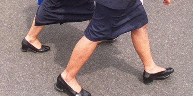 Two Indonesian secretaries walk through the centre of Jakarta. The governor of an Indonesian province has ordered his top staff to replace their female secretaries with men following a string of extra-marital affairs.