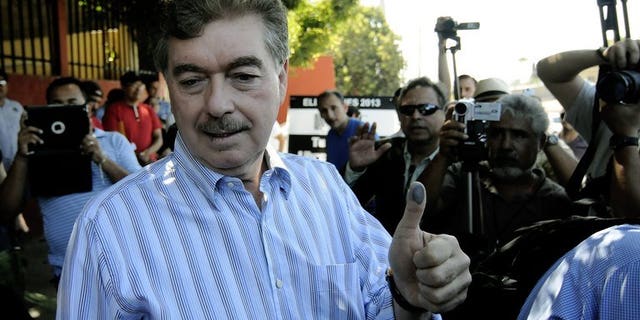Baja California's candidate for governor Francisco Vega, shows his inked thumb after casting his vote in Tijuana, Baja California, on July 7, 2013. Mexico's conservative opposition retained the governor's seat in Baja California after the ruling party candidate conceded defeat Saturday following a recount in the politically crucial state.