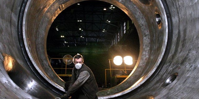 This file photo shows an employee of the Izhorsky engineering plant in St.Petersburg polishing the interior of a 1,000-megawatt nuclear power reactor for Indian nuclear power plant in Kudankulam, on November 18, 2004. The Russian-built Kudankulam plant is India's biggest nuclear power project and is designed to help meet a surging demand for electricity in Asia's third-largest economy