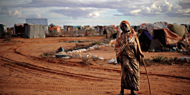 An elderly woman displaced by violence walks in a refugee camp in the northern breakaway state of Puntland on October 17, 2009. Somalia's semi-autonomous northern region has suspended long-awaited local elections, its government said, saying the risk of violence was too great to hold them.