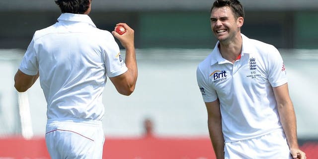 England's James Anderson (R) celebrates with England's Alastair Cook after claiming the wicket of Australia's Mitchell Starc during the fifth day of the first Ashes cricket test match between England and Australia at Trent Bridge in Nottingham, central England, on July 14, 2013.