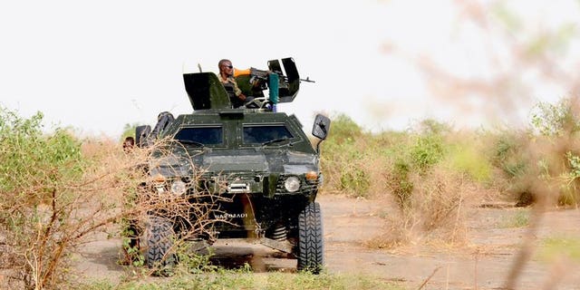 Nigerian soldiers patrol in the north of Borno state close to a former camp of the Islamist extremist group Boko Haram, on June 5, 2013 near Maiduguri. Nigeria's military on Sunday claimed the rescue of women and children hostages from a Boko Haram Islamist stronghold, saying troops killed several insurgents during recent gun battles in the area.