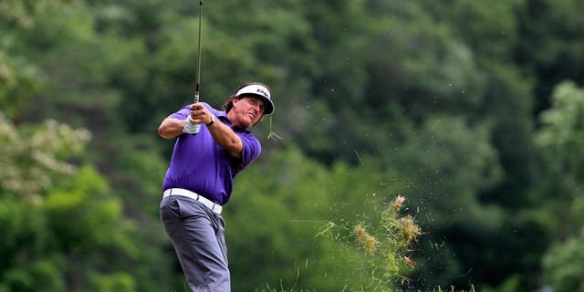 Phil Mickelson watches his second shot on the 6th hole during round two of the Greenbrier Classic at the Old White TPC on July 5, 2013 in White Sulphur Springs, West Virginia. Mickelson heads to the British Open in the best form possible after ending a 20-year European winless drought with a play-off victory in the Scottish Open on Sunday.