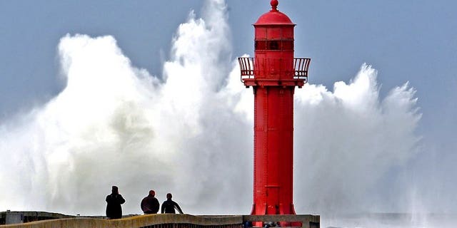 Waves rise up at the port of Boulogne-sur-Mer on March 11, 2008. A British woman died trying to swim across the Channel between Britain and France over the weekend, police and the Foreign Office said.