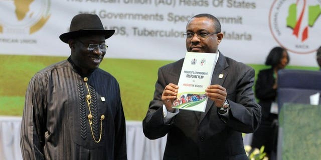 Nigeria's President Goodluck Jonathan looks on as Ethiopian PM Hailemariam Desalegn displays a publication at the opening session of the African Union Summit on health focusing on HIV/AIDS, TB and Malaria in Abuja on July 15, 2013. African leaders called for increased funding Monday to contain HIV/AIDS, TB and malaria as the continental health summit opened in Nigeria's capital.