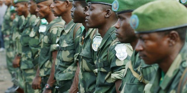 DR Congo's national army FARDC soldiers stand in formation in Karisimbi, south of Goma, on May 27, 2013. Rwanda's military spokesman said two mortar bombs were fired into the country from neighbouring DR Congo on Monday, blaming the DRC army - the FARDC - and the UN force MONUSCO.