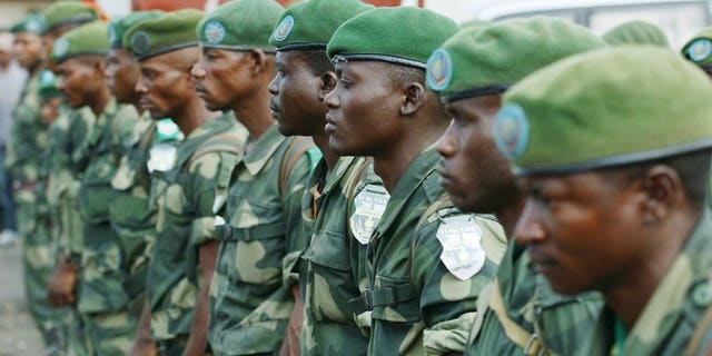 DR Congo's national army FARDC soldiers stand in formation in Karisimbi, south of Goma, on May 27, 2013. Rwanda's military spokesman said two mortar bombs were fired into the country from neighbouring DR Congo on Monday, blaming the DRC army - the FARDC - and the UN force MONUSCO.