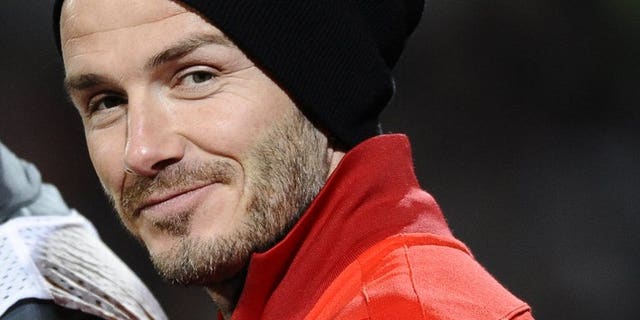 David Beckham smiles on May 26, 2013 at the Moustoir stadium in Lorient, western France. Football superstar Beckham recommended his friend Prince William and his wife Catherine call their baby David if it's a boy.