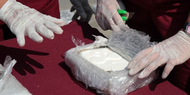 Criminology specialists test cocaine seized in Maracaibo, Zulia state, Venezuela, on April 25, 2013. Spanish police said Monday they had arrested a notorious British drug dealer, Brian Charrington, whom they accused of running an international trafficking racket involving cocaine from Venezuela.