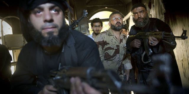 Syrian rebels take position during clashes with regime forces in Aleppo, on May 22, 2013. Iran says it would welcome ceasefire between rebel forces and the Syrian government during the Muslim holy month of Ramadan, reiterating that a national dialogue was the only way to resolve the crisis.