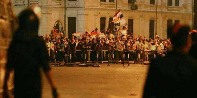 Supporters of the Muslim Brotherhood and of Egypt's ousted Islamist president Mohamed Morsi block the Six October Bridge in the center of Cairo on July 16, 2013. Seven people were killed and 261 wounded in overnight clashes in Cairo between supporters of Morsi and security forces, health officials said on Tuesday.