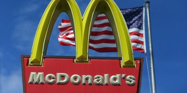 A sign for a McDonald's restaurant pictured in front of an American flag in Miami, Florida on July 23, 2012. McDonald's said Tuesday it would launch its first restaurant in communist Vietnam next year after granting a franchise to the son-in-law of Prime Minister Nguyen Tan Dung.