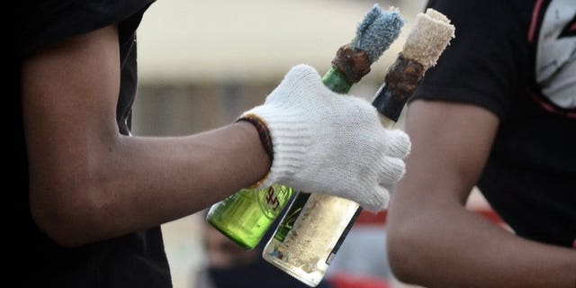A Bahraini protester holds Molotov cocktails during clashes with riot police in Sitra, on June 7, 2012. Bahraini authorities have arrested three "terrorists" who allegedly hurled firebombs at the home of a Shiite lawmaker without causing casualties even though he was inside when the assault occurred.