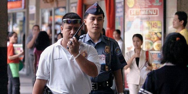 Policemen patrol in suburban Manila on February 16, 2005. An Australian resident of Hong Kong has been arrested for sexually abusing children in the Philippines, police said Tuesday.