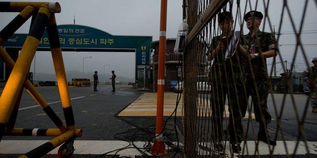South Korean soldiers stand at a military checkpoint leading to North Korea's Kaesong joint industrial complex, in the border city of Paju early on July 10, 2013. North and South Korea will hold fresh talks Wednesday on reopening their joint industrial zone as hopes of an early agreement fade following months of friction.