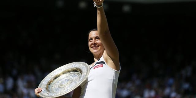 France's Marion Bartoli after winning Wimbledon on July 6, 2013. Bartoli will team up with the popular Jo-Wilfried Tsonga for France to open their 2014 season at the Hopman Cup in Perth.