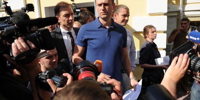 Russia's top opposition figure Alexei Navalny addresses journalists and supporters after visiting the city's election commission office to submit documents to get registered as a mayoral election candidate in Moscow July 10, 2013. Moscow authorities on Wednesday accepted Navalny's candidacy to run in mayoral polls, a day before a verdict is due in his trial on fraud charges.