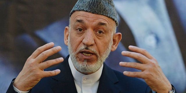 Afghan President Hamid Karzai speaks during a joint press conference with NATO Secretary General Anders Fogh Rasmussen at a military academy outside Kabul on June 18, 2013. Karzai on Wednesday approved changes to the make-up of Afghanistan's electoral complaints watchdog, removing foreign UN representatives before presidential polls next year.