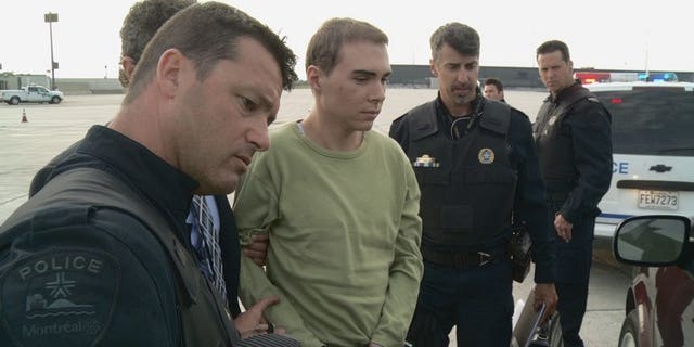 This photograph obtained courtesy of the Service de Police de la Ville de Montreal (SPVM) shows Luka Rocco Magnotta (C) escorted by police upon arrival from Germany on June 18, 2012.