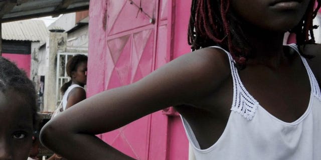 Gabonese youths stand outside a shop in Libreville on September 6, 2009. West African human trafficking is spawinging a Gabonese hell for some children.