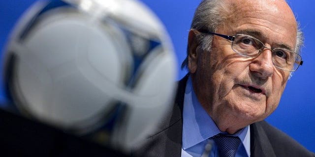 FIFA President Sepp Blatter looks on behind a football during a press conference on September 28, 2012 in Zurich. Blatter will push for the 2022 World Cup in Qatar to be moved to the winter after getting a personal taste of the Middle East's blast furnace climate.