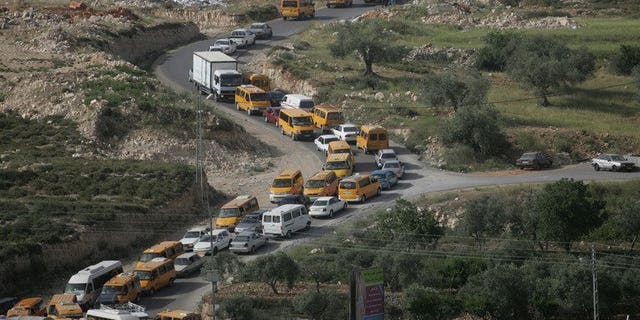 Palestinian vehicles are stuck in traffic on the main road linking the West Bank city of Ramallah with the nearby town of al-Bireh after Israeli troops forced hundreds of motorists to queue for ID checks on April 23, 2008. The Israeli military is preparing to lift some restrictions on Palestinian movement in advance of possible renewed peace talks, according to army radio.
