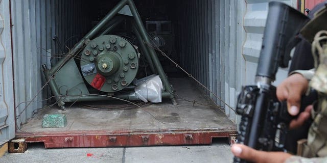 A Panamanian soldier guards a container on the North Korean ship Chong Chon Gang, in which Soviet-era weaponry was found, at Manzanillo Port in Colon, Panama, on July 17, 2013. North Korean sailors whose dilapidated ship was halted near the Panama Canal and found to be carrying the military equipment could face up to six years in jail, a prosecutor has said.
