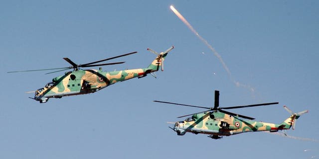 SYrian helicopters take part in military manoeuvres at an undisclosed location on December 20, 2011. A Syrian military helicopter fired rockets at a pro-rebel region of eastern Lebanon in the early hours of Thursday, a security source told AFP.