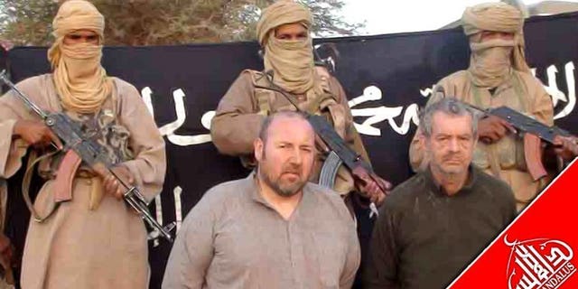 A picture released in December 2011 shows Philippe Verdon (right) and Serge Lazarevic at an undisclosed location. French hostage Verdon, who was kidnapped by Al-Qaeda in the Islamic Maghreb (AQIM) in Mali in 2011 and found dead several weeks ago, was executed with a shot to the head, prosecutors said Thursday